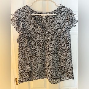 Large black and white top with ruffles on the sides.
